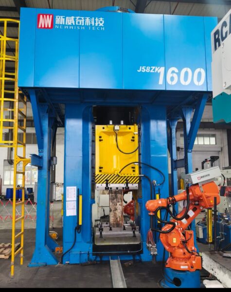 Large industrial forging press machine with automated manufacturing equipment